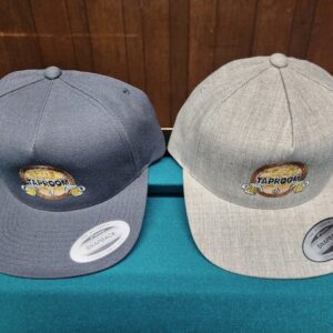 Two embroidered caps on a table