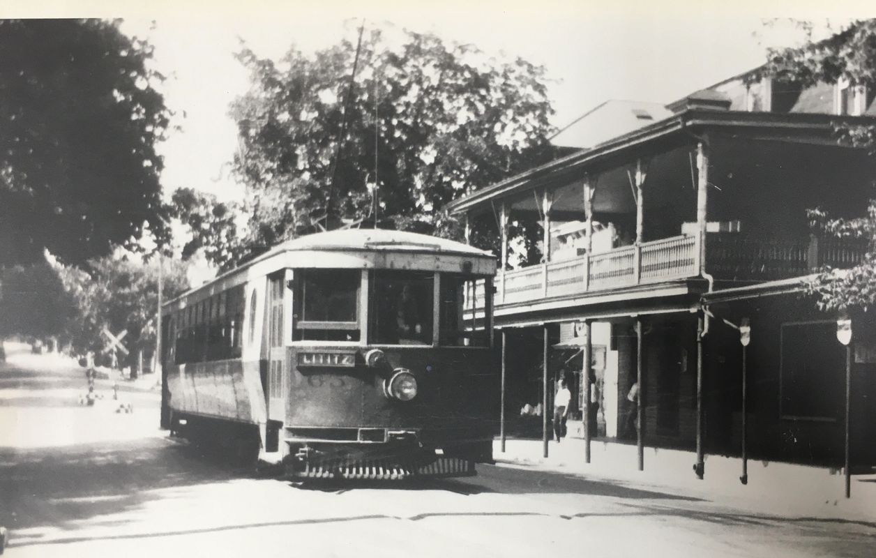 Classic trolley near a vintage house